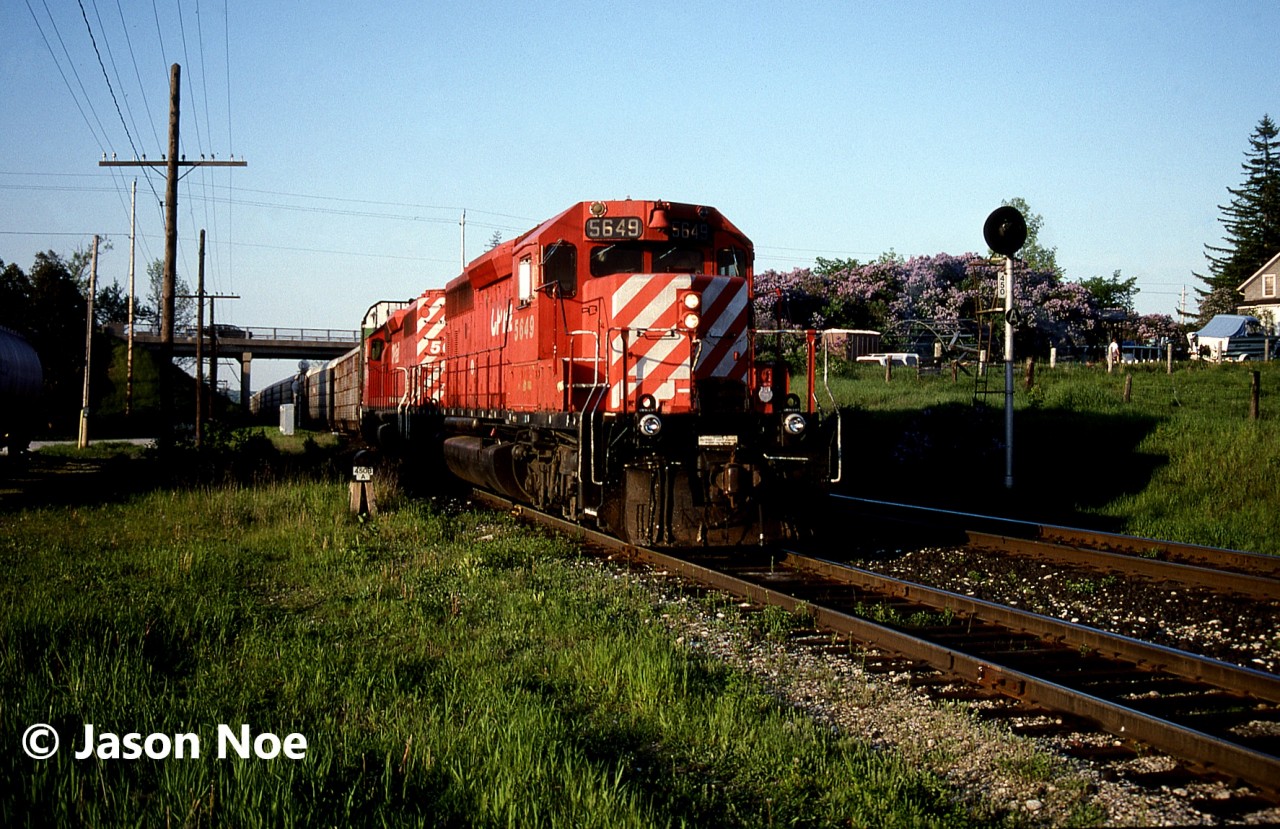 During a spring evening, CP auto train 737 with SD40-2’s 5649 and 5682 is pictured entering the siding at Puslinch, Ontario on the Galt Subdivision for a meet with an eastbound. Having already photographed the train near the ski hill in Halton Hills, this was the second time the friendly crew had seen my friends and I. As the train was coming into the siding it slowed to a stop and the engineer yelled down to us, “Hey do any of you want to come for a ride to Orrs Lake?” About thirty seconds later after a quick discussion with my friends, I climbed into the cab of 5649 and the auto train slowly began moving into the siding at Puslinch.