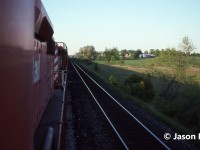 Leaning out of the cab of 5649 west, here is the view captured looking back as 737 enters the siding at Puslinch, Ontario on the Galt Subdivision for a meet with an eastbound. At the time, 737 was a dedicated auto train and on this evening the friendly crew had invited a friend and I along for a cab ride to the top of Orrs Lake hill from Puslinch. The consist included SD40-2’s 5649 and 5682. 