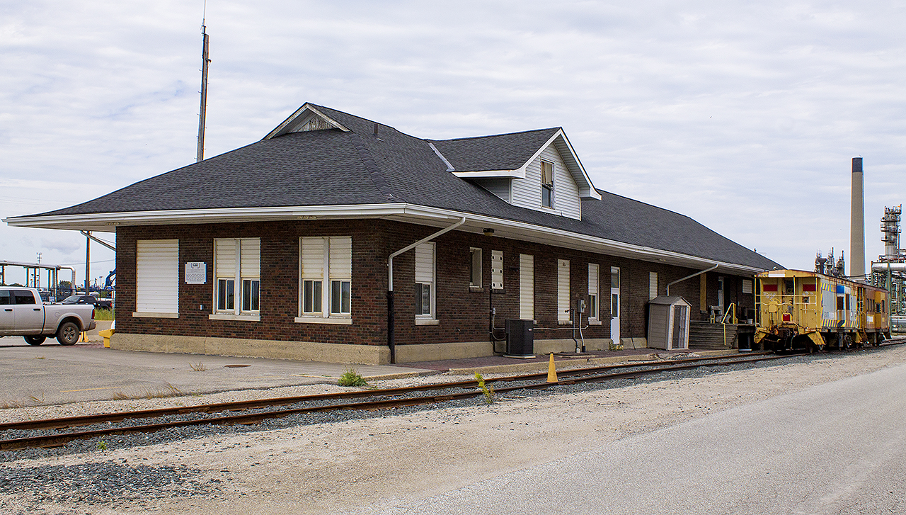 Any trip to the area, and I'll be checking on all rail activity. Having been in Sarnia for a special day with my daughter who was 2.5 yrs old at the time, we drove the family sedan into the industrial area near the end of Clifford Street to stop at the old C&O station.


When one does this, it is under very watchful eyes. This day was no different  however, I rolled down the window and spoke to a railway employee. He seemed baffled why I'd drive in here with a toddler, but gave permission with strict rules of keeping safe.


Needless to say, I never stepped out of the car. I angled it, and quickly snapped a couple of photos of the rear of this old building. Looking back, I wish I drove closer up to the two, flat roofed vans to have taken better photos. Upon my last trip back here this past summer, neither of these old relics were there, and the siding was removed.