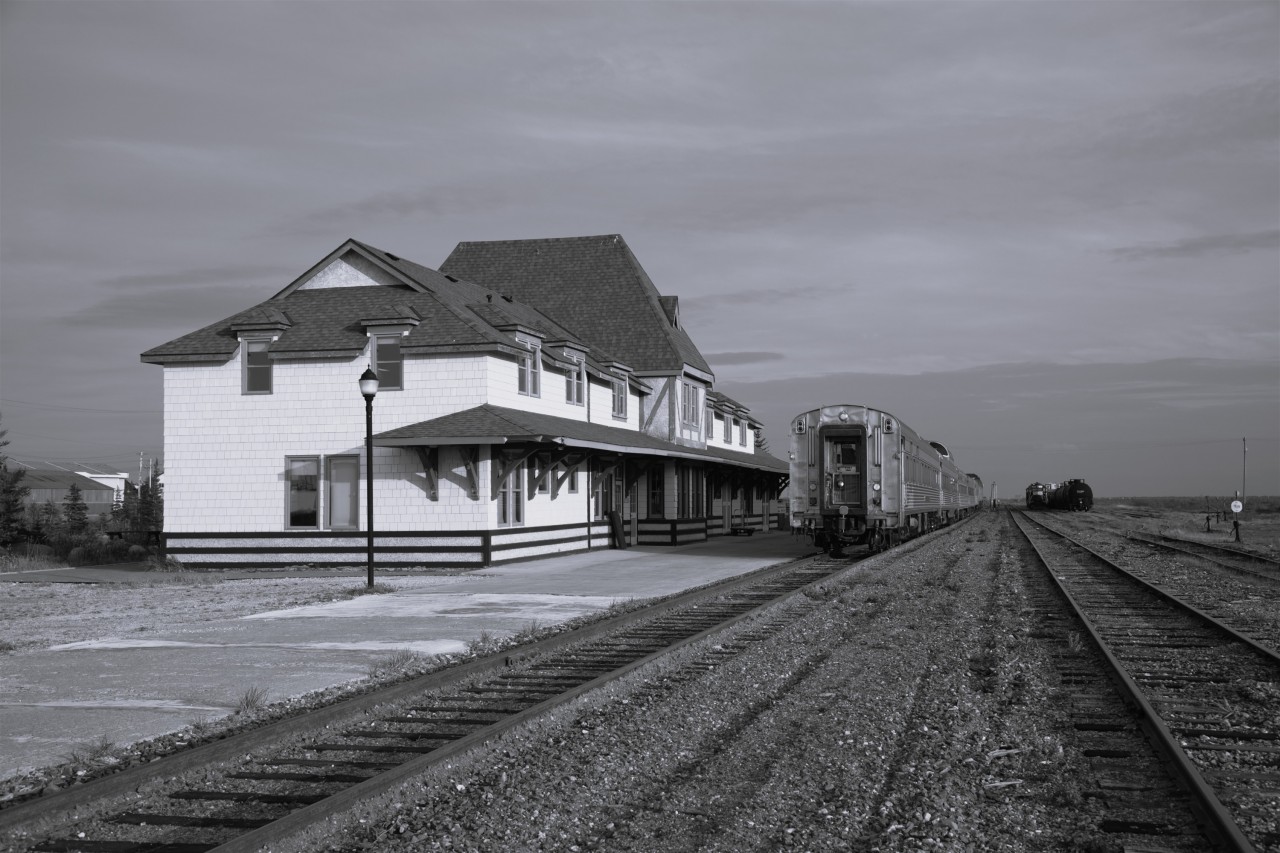 Serene setting  
The consist of VIA 692 The Hudson Bay is parked on the station track in Churchill this late September afternoon waiting for passengers to arrive for the journey to Winnipeg. 
In a few hours the station will open, and the platform will be busy with baggage vehicles, VIA staff, and anxious travelers.