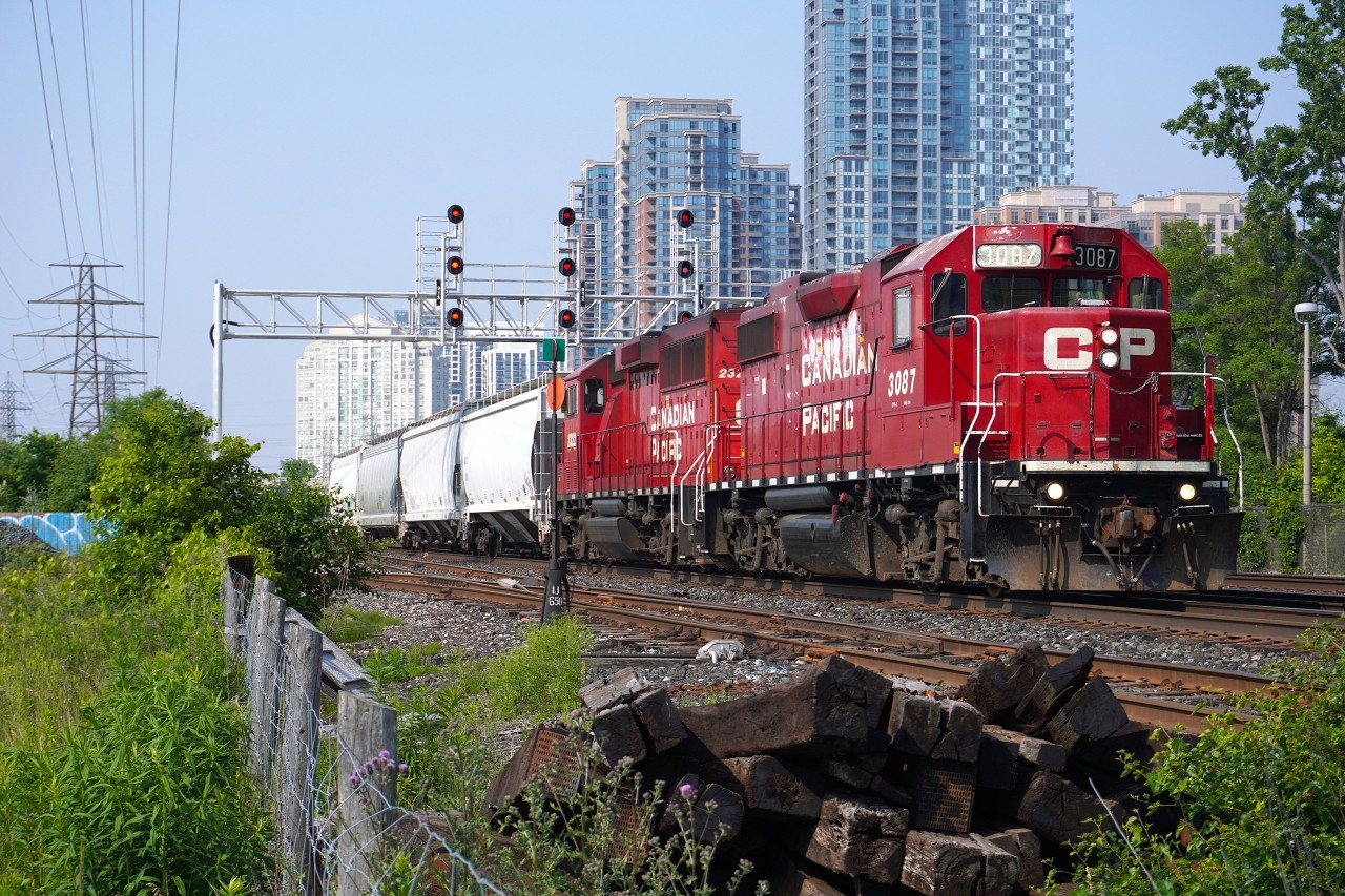 GP38-2 CP 3087 leads with GP20C-ECO CP 2322 trailing on a CPKC Galt Sub local past the Westward signal bridge at Obico towards the Bloor controlled location where they backed into the spur in the foreground to service the industries South of here.