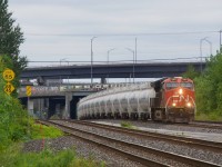 After refueling and getting a new crew, an empty TankTrain unit train heads east.