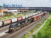 CN 529 with NS 3653 & NS 4171 for power passes grain cars parked on Track 29.