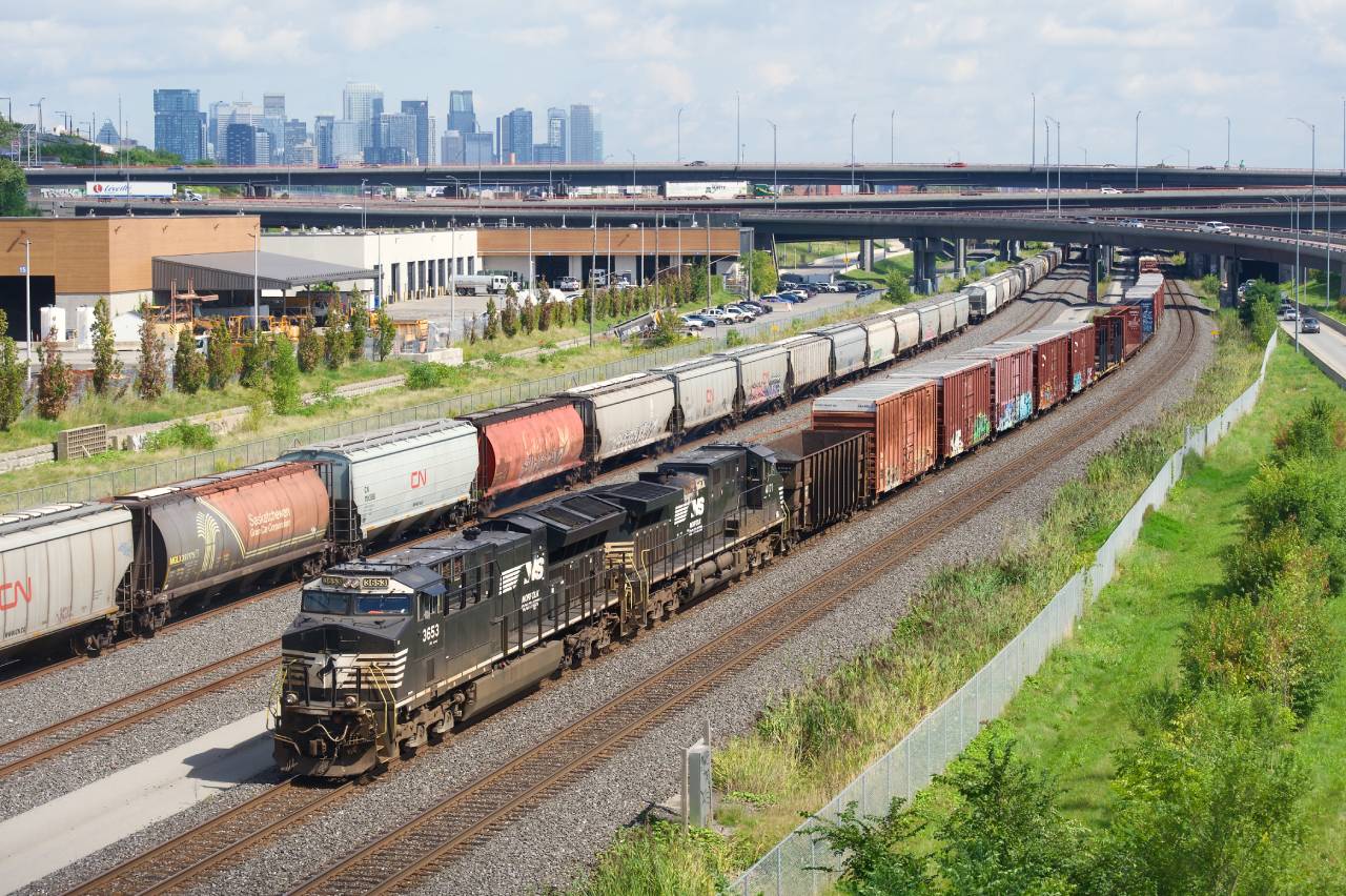 CN 529 with NS 3653 & NS 4171 for power passes grain cars parked on Track 29.