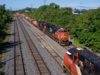 CN 126 passes a parked CN 305 as it exits Taschereau Yard with tonnage for the Port of Montreal. They will leave the cars on the Transfer Track near Turcot Ouest and CN 596 will take it to the port later that day.