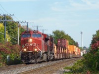 CP 7548 leads CPKC 133 over a dip on the Vaudreuil Sub. Up front is an older TFM 5-pack. The whole train has quite a mix of cars, with intermodal followed by mixed freight, autoracks and then a bit more intermodal.