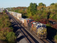 A slightly late CN 120 heads east through Beaconsfield with a test box car behind the power.