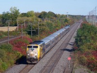 VIA 67 is westbound through Sainte-Anne-de-Bellevue with VIA 907 leading. A bilingual stop sign at right shows the end of track for a backtrack that is sometimes used for maintenance of way vehicles.