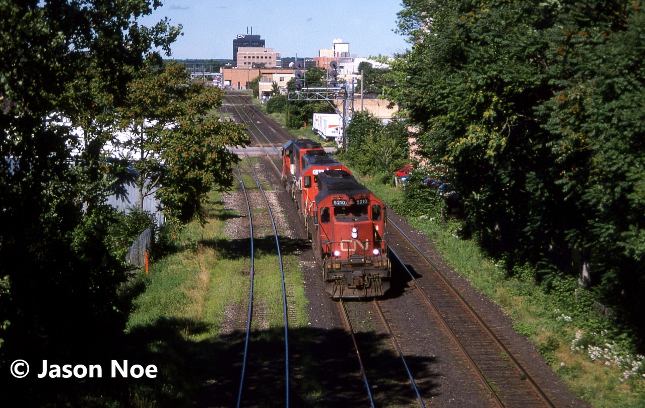 A CN eastbound light power move is seen rolling through London, Ontario on the Dundas Subdivision. The consist included; CN 5210, GTW 6416 and GTW 5923 with both trailing units repainted in the current CNNA scheme at the time.