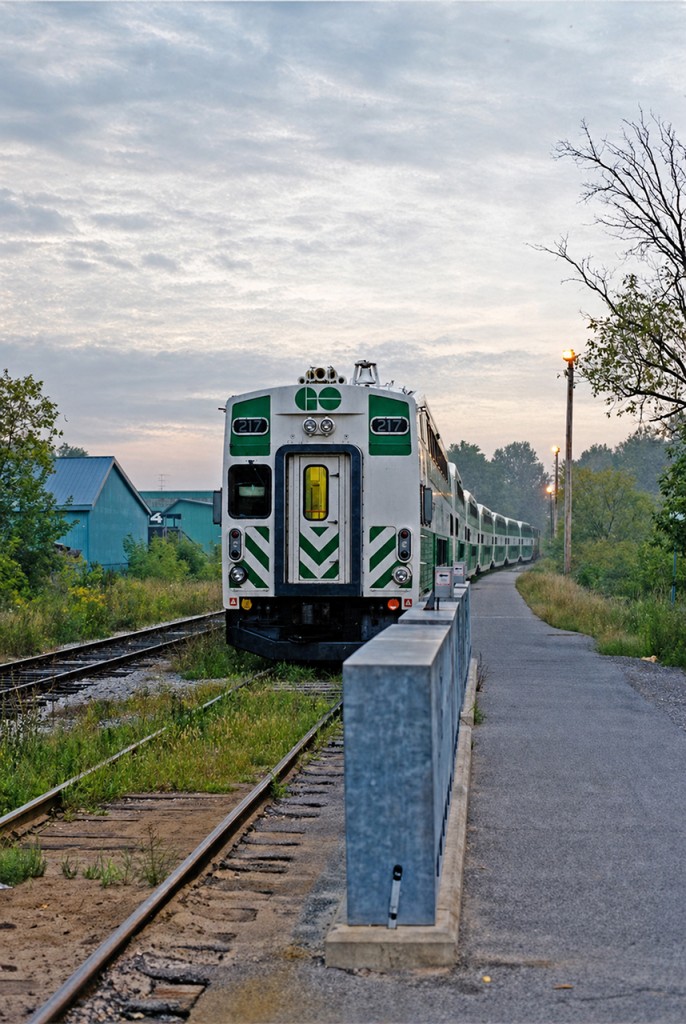 GO cab car #217 sits just north of the station in Stouffville with a 7-car train and F59PH 561 on the other end of the consist, about to spring to life to bring a train full of morning commuters to the big city.  This would be the second of two weekly-only morning trains to Toronto Union Station. Times sure have changed, as today the active line has been extended past this location and service is available more or less all-day, all-week. Significant improvements have also made to the track and other infrastructure. While changes were obviously necessary and positive, there was something fascinating about riding the line back then; old, jointed rail on a single-track line, mostly overgrown with grass and weeds while passing through backyards, fields and forests. I believe the maximum speed anywhere on the line back then was 50mph, but I could be mistaken. For a railfan like me, it was fun riding in the cab car and looking forward down the line (it was especially rocky once the train left Stouffville!), or behind the locomotive on the northbound trip, listening to the seemingly non-stop use of the beautiful K5LA horn for the many grade crossings. A major difference from the more sophisticated Lakeshore line at the time. I wish I had it in me to photograph the line at other areas along the way, but a student schedule and limited time (and foresight!) prevented that from happening.