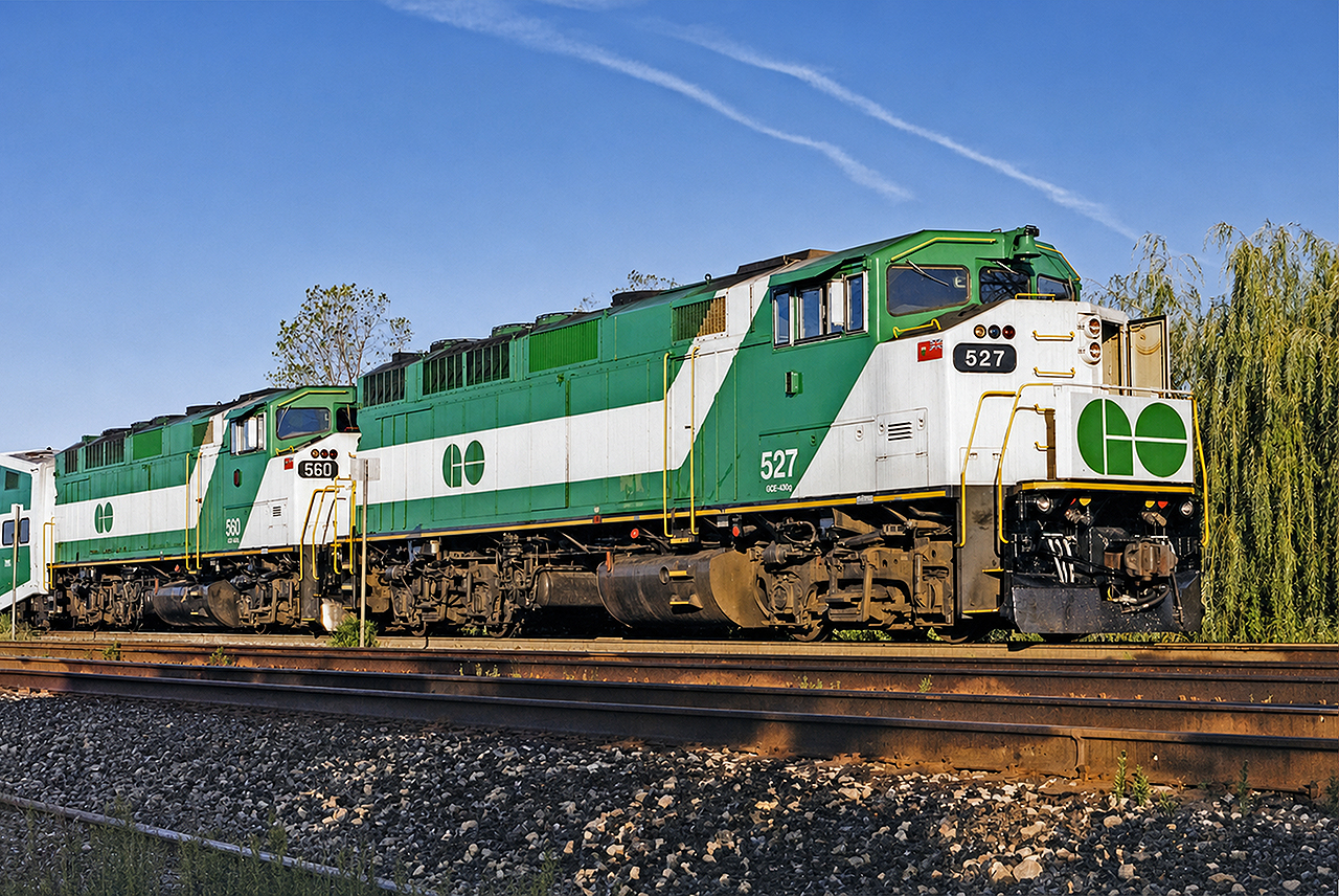 GO F59PH #527 along with sister 560 rest at Burlington, before leading a CNE weekend-sized Lakeshore line train back east towards Toronto and Oshawa. The 527 had already been overhauled, and the 560 was soon to enter the shops for a mid-life rebuild as well. At the time, Burlington was the farthest west terminus for regular train service (aside from a handful of weekday-only rush hour trains to Aldershot and Hamilton GO Centre), and the then-track 1 was still on the north side of the platform. Today, everything has been realigned, and this photo would no longer be possible.