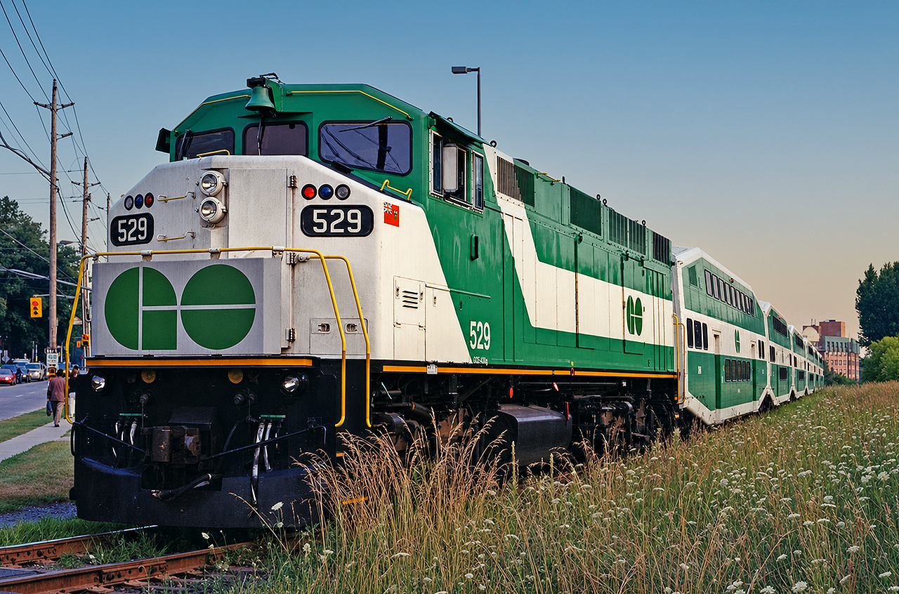 GO F59PH #529 idles at Markham on a warm August evening in 2001. At the time, GO began modestly expanding service on the Stouffville line, with a morning and evening turn from Toronto Union Station to Markham and back, in passenger service both directions (no deadheading equipment moves). I took this opportunity to ride up and back on both the morning and evening runs. The 10 minutes or so for the turn in Markham afforded the possibility of a few quick pictures. The 529 was unique in that it was the only F59PH to retain its original number boards after its midlife overhaul- for what reason, I do not know. This unit remains on the rails at the time of this posting, now owned by Amtrak/NCDOT hauling passengers between Charlotte and Raleigh, North Carolina (also my home State now).