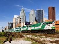 GO F59PH 557 and sister 522 lead a string of 10 bilevels out of Toronto Union Station, eastbound for Oshawa on a late Saturday morning. The Exhibition was on and GO regularly added a second locomotive to its weekend Lakeshore line trains to assure schedules were met with the heavier crowds. This near-trackside location was just above Jarvis Street and was quite easily accessible buy foot, without trespassing or getting fussed at by anyone. Times sure have changed, as has the Toronto skyline.