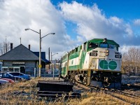 GO F59PH 558 prepares to depart Bradford with a southbound deadhead train to Toronto Union Station. It is December 23rd 1999 and early afternoon. Typically, there would be no GO train service here at this time of day, but it GO operated a modified rush hour schedule the days before Christmas and New Years Eve to get commuters home in time before evening festivities. This was the first train of the early afternoon to depart Union Station for Bradford, and I rode it to get some pictures that would have otherwise been impossible during that time of day in 1999.  This was a 7-car consist with cab car 215 at the other end, back before their rebuilds when one could stand next to the hogger and observe the tracks ahead. If you look closely, the engineer operating the 558 back to Union can be seen wearing a Santa hat. This photo was taken with my Nikon F50 and Nikkor lens, using Kodak film. Digital photography had not yet taken over and it was anyone's guess how a roll of film would turn out...while those may have been simpler times in some respects, they certainly were also a lot more difficult in others.