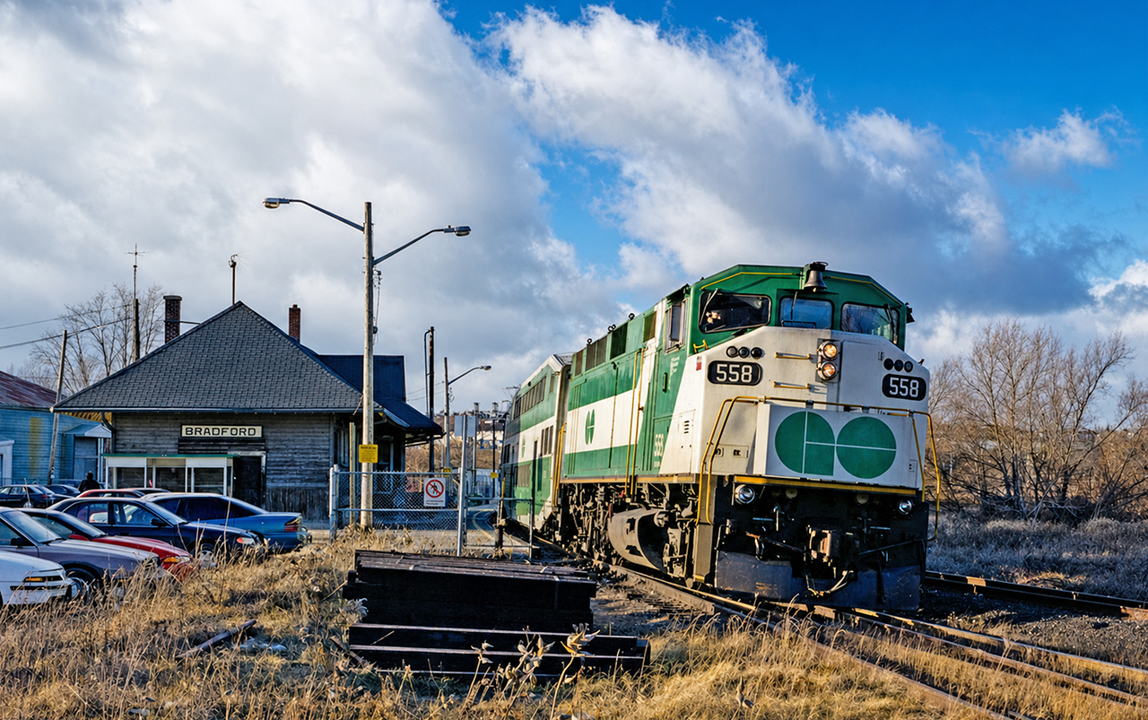 GO F59PH 558 prepares to depart Bradford with a southbound deadhead train to Toronto Union Station. It is December 23rd 1999 and early afternoon. Typically, there would be no GO train service here at this time of day, but it GO operated a modified rush hour schedule the days before Christmas and New Years Eve to get commuters home in time before evening festivities. This was the first train of the early afternoon to depart Union Station for Bradford, and I rode it to get some pictures that would have otherwise been impossible during that time of day in 1999.  This was a 7-car consist with cab car 215 at the other end, back before their rebuilds when one could stand next to the hogger and observe the tracks ahead. If you look closely, the engineer operating the 558 back to Union can be seen wearing a Santa hat. This photo was taken with my Nikon F50 and Nikkor lens, using Kodak film. Digital photography had not yet taken over and it was anyone's guess how a roll of film would turn out...while those may have been simpler times in some respects, they certainly were also a lot more difficult in others.