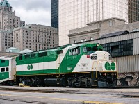 GO F59PH 564 departs Toronto Union Station eastbound towards Pickering. It is a cold and cloudy Christmas Eve of 1997, and the 564 was recently put back into service after a lengthy time in storage. It remains GO's newest F59PH, after sisters 565-568 were sold to Trinity Railway Express (TRE) in Dallas, Texas amid provincial government cutbacks of the mid-1990s. Despite only being built in 1994, units 562-564 were kept in long-term storage at Willowbrook, along with sisters 520-523 before being placed back into service shortly before this image was taken. This is another photo location that is no longer possible, due to the buildout and modernization of Union Station and surrounding area. The Royal York Hotel still stands, but the historic train shed in the background has long since been leveled.