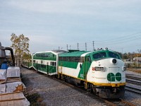 GO FP7 APCU #903 trails a westbound hourly Lakeshore service to its final stop at Oakville. The APCUs (Auxiliary Power Control Unit) were purchased- or transferred given that they came from another provincial entity- used, from Ontario Northland. They were de-engined and retrofitted with a head end power generator used to heat, cool and light the coaches given that the GP40-2Ws and GP40-2Ms did not have a HEP generator of their own. Having a control cab also eliminated any need to turn a consist at the end of a line. They were always my favorite pieces of equipment to observe and ride behind on GO Transit. Photo is a scan from a print I purchased at the Toronto train show in the early '90s.