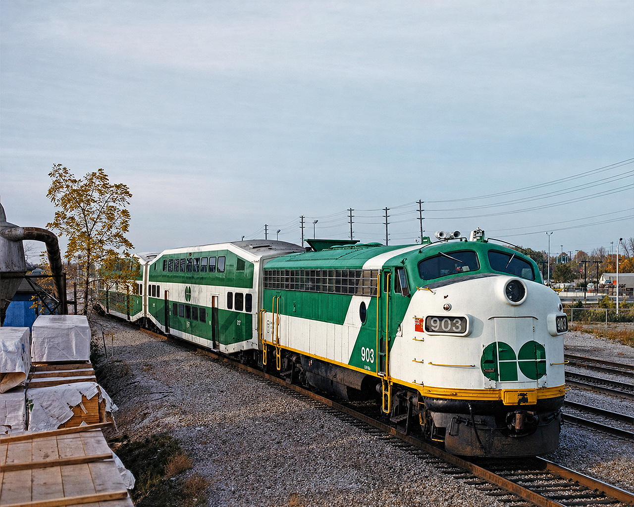 GO FP7 APCU #903 trails a westbound hourly Lakeshore service to its final stop at Oakville. The APCUs (Auxiliary Power Control Unit) were purchased- or transferred given that they came from another provincial entity- used, from Ontario Northland. They were de-engined and retrofitted with a head end power generator used to heat, cool and light the coaches given that the GP40-2Ws and GP40-2Ms did not have a HEP generator of their own. Having a control cab also eliminated any need to turn a consist at the end of a line. They were always my favorite pieces of equipment to observe and ride behind on GO Transit. Photo is a scan from a print I purchased at the Toronto train show in the early '90s.