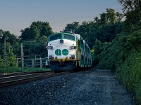 GO FP7 APCU 907 trails an evening rush hour train through Bayview from Toronto Union Station to Hamilton, with recently installed ditch lights. These Auxiliary Power Control Units (APCU) were common on GO Transit throughout the 1980s into the early 1990s, as the GP40-2W and GP40-2M locomotives lacked HEP power generators of their own. Scanned slide from GO564 collection and restored, original photographer unknown.