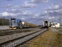 <b> Work train at the ready </b> <br>
GREX 2400 is the power and unloading conveyor car for the loaded ballast train ready to head out and dump more stone for the continuing rehabilitation of HBR's tracks to the port in Churchill, MB. <br>
Having taken the VIA 693/692 round-trip from Winnipeg to Churchill twice a year for the past four years I have witnessed the incredible improvements in the roadbed and other infrastructure all along the line. <br>
My next trip is coming up on October 19-25, 2026 and I will be looking to snap some more interesting sights along the remote route for posting to RP. <br>
At the right of the frame, sleeping car VIA 8202 Chateau Bienville brings up the tail-end 'paddle' and rear-facing white light on VIA 693 The Hudson Bay during its scheduled multi-hour station stop in Thompson.