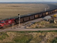 The coal dust is flying as CPKC 820-902 highballs through MacKid, Saskatchewan.  In the distance, the elevator at Maple Creek can be seen, across an otherwise empty prairie.  Coal trains on the prairies are rather rare, with only a handful a year operating to Thunder Bay.  