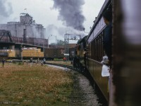 Departing West Toronto station, an Ontario Rail Association trip to Orangeville behind ex CPR D10 1057 swings through the Galt Sub curve at the Lambton mileboard.  Local industries, a passing freight, and the Weston Road overpass complete the scene.


<br><br><i>Scan and editing by Jacob Patterson.</i>