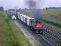 Rolling out of Mac Yard onto York three, CN M420 2572 takes charge of a short freight, throttling up by Keele Street.  Shortly after 2572 clears, <a href=https://www.railpictures.ca/?attachment_id=56821>a special move</a> to Allandale and Beeton will depart with equipment for the <a href=https://www.railpictures.ca/?attachment_id=57017>startup of the South Simcoe Railway.</a><br><br><i>Scan and editing by Jacob Patterson.</i>