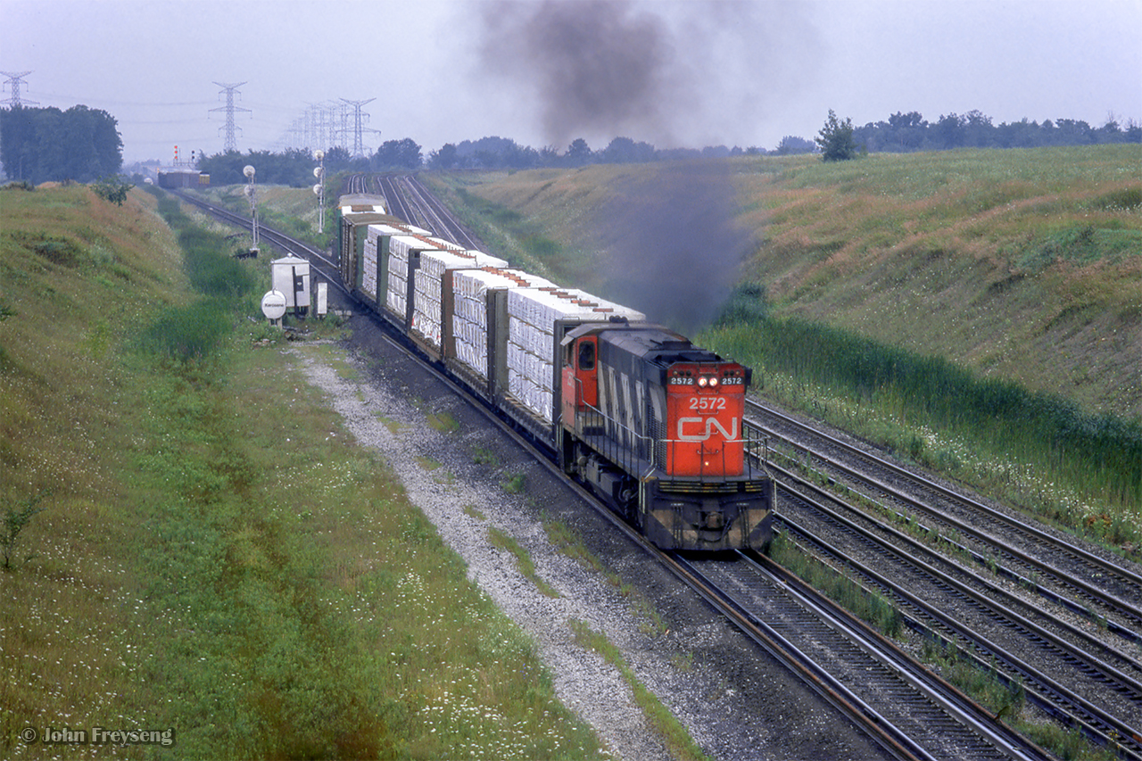 Rolling out of Mac Yard onto York one, CN M420 2572 takes charge of a local freight, throttling up by Keele Street.  Shortly after 2572 clears, a special move to Allandale and Beeton will depart with equipment for the startup of the South Simcoe Railway.

Scan and editing by Jacob Patterson.