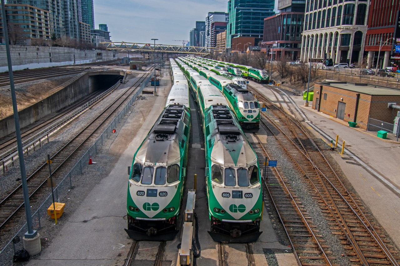 A group of Go Transit trains sitting in their yard, waiting for the afternoon commute to begin.