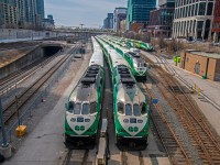 A group of Go Transit trains sitting in their yard, waiting for the afternoon commute to begin.