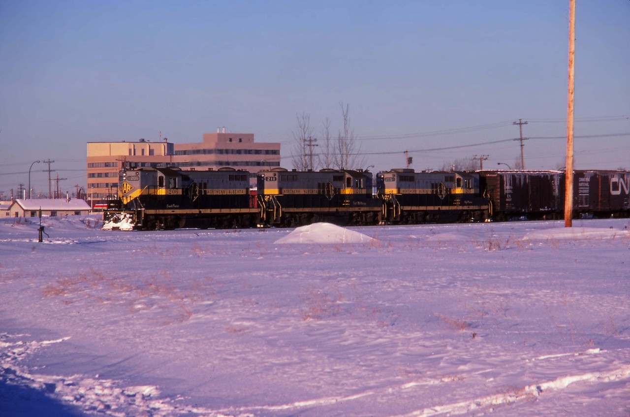 On January 1, 1981 Canadian National assumed sole ownership of the Northern Alberta Railways which previously had been jointly owned with Canadian Pacific. This slide, processed in January 1981, shows GP9s 206, 211, and 205 ready to head north from Dunvegan yard. These units would be renumbered into CN's 4600 series later in 1981.
