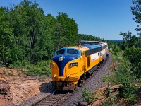 Ontario Northland FP7ACat #2000 leads the northbound "Northlander" out of North Bay, on a clear June day in 1995. This F-unit had been recently rebuilt from FP7A #1502- the original GMD motor was replaced with a Caterpillar prime mover, which proved to be more cantankerous than originally hoped for. Two other FP7s would undergo the rebuild program and although they looked great, they did not remain in service past the early 2000s. The overhaul program was very in-depth and included a complete overhaul of the engine and electrical systems, as well as installation of desktop controls. It's a shame the ONR didn't opt to just keep the original GMD prime mover as their GP9s that shared the same platform are still in use as of this posting.