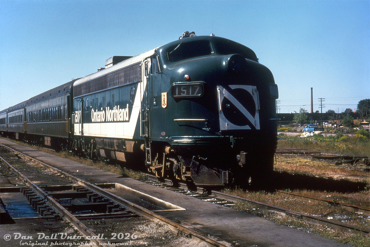 Here's a nice GO Transit locomotive on the head end of its GO train at GO's Willowbrook Yard: Ontario Northland FP7 1517! Back when GO first launched, they planned to expand to full service in September 1967 using some of their ordered-but-not-yet-delivered self-powered Hawker Siddeley cars (D100-D108, later 9825-9833) to cover those runs. Unfortunately, those cars were late to be delivered, and since they were a new design of unknown reliability, had to be tested and troubleshot before being put into service (and according to the old "Building GO Transit" article there were problems, notably with the English-made Rolls-Royce engines constantly shutting down). So as an interim measure, the Ontario government borrowed two sets of conventional trains from Ontario Northland, composed of an FP7 at each end of 5 or so older coaches.

GO experimented with various configurations, including both FP7's at one end, and one FP7 per end but only one powering the train in each direction, and determined both units had to be online and providing power to maintain the tight commuter schedules. The solution reached was an FP7 at both ends connected with long MU cables running along the coaches, enabling both units to be online and respond as one. The two Ontario Northland consists operated in GO service during 1967-1968. Two "Progressive" paint scheme units (1517 and 1521) were among the ONR FP7's that did time on these trains. The self-powered cars coming online and a follow-up order for 14 more unpowered coaches in 1968 seemed to alleviate the equipment shortage, and the ONR consists were returned.

The self-powered cars proved to be more troublesome than they were worth, and GO neutered them by depowering all nine and converting them into regular cab cars. Some of those Ontario Northland F's would come back in the 70's as unpowered control cab/generator cars (APCU's), rebuilt for GO by Ontario Northland.

This photo spot is around the northeast end of the old Willowbrook Yard shop buildings (the former CN Mimico Yard car repair shop that GO originally took over) just east of present-day Islington Avenue, where the UPX servicing shop is today. The blue pickup truck in the background sits by a CN service track that ran along the north end of the yard, formerly CN's Oakville Sub mainline right-of-way until it was relocated to the middle of the yards concurrent with GO establishing facilities here. In the far distance are the old Ontario Ministry of Transport buildings that were used for ambulance upfitting for sale to municipalities across the province for many decades.
Original photographer unknown, Dan Dell'Unto collection slide (duplicate).