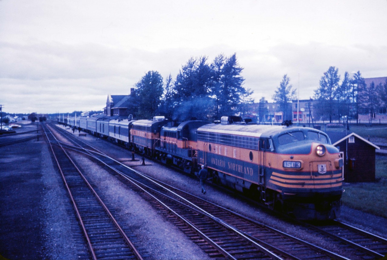Here is an intriguing photo from the 1960s. Although there is no information on this undated slide, it appears to show the "Northland" southbound at Cochrane with an unusually large train for the sparsely populated area. According to a 1962 timetable in my collection, No. 50 originated on CN at Hearst, departing at 2:30 PM and arriving at Cochrane at 6:00 PM before continuing south over the Ontario Northland at 6:30 PM.  CN took the train over again at North Bay for the trip to Toronto (via the Newmarket sub to Washago and the Bala sub for the rest of the trip) arriving at 8:00 AM daily except Sunday. (In 1962, a second train--No. 46--ran Timmins and North Bay to Toronto using CN's Newmarket sub south of Washago. By 1967, there was only one train south of North Bay and train service had been cut back to Kapuskasing with a bus to Hearst and connecting ONR trains between Timmins and Porquis.)

Equipment notes in the October 28, 1962 public timetable state: "Trains 49-50-Toronto-North Bay-Timmins-Noranda-Cochrane-Kapuskasing-Hearst. 
Cafe Car-Toronto-North Bay. 
Cafe Lounge-Englehart-Hearst. 
Sleepers: 
Cars 4900, 5300 8-Sec., 2 Cpt., 4 D. R.-Toronto-Noranda. (except Saturday). 
4901, 5001 8-Sec., 4 D.B.R., Toronto-Hearst. (Except Saturday). 
4902, 5002 4-Sec., 8 Duplex Rmtte., 4 D.B.R.-Toronto-Timmins. 
(except Saturday)."