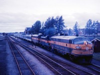 Here is an intriguing photo from the 1960s. Although there is no information on this undated slide, it appears to show the "Northland" southbound at Cochrane with an unusually large train for the sparsely populated area. According to a 1962 timetable in my collection, No. 50 originated on CN at Hearst, departing at 2:30 PM and arriving at Cochrane at 6:00 PM before continuing south over the Ontario Northland at 6:30 PM.  CN took the train over again at North Bay for the trip to Toronto (via the Newmarket sub to Washago and the Bala sub for the rest of the trip) arriving at 8:00 AM daily except Sunday. (In 1962, a second train--No. 46--ran Timmins and North Bay to Toronto using CN's Newmarket sub south of Washago. By 1967, there was only one train south of North Bay and train service had been cut back to Kapuskasing with a bus to Hearst and connecting ONR trains between Timmins and Porquis.)

Equipment notes in the October 28, 1962 public timetable state: "Trains 49-50-Toronto-North Bay-Timmins-Noranda-Cochrane-Kapuskasing-Hearst. 
Cafe Car-Toronto-North Bay. 
Cafe Lounge-Englehart-Hearst. 
Sleepers: 
Cars 4900, 5300 8-Sec., 2 Cpt., 4 D. R.-Toronto-Noranda. (except Saturday). 
4901, 5001 8-Sec., 4 D.B.R., Toronto-Hearst. (Except Saturday). 
4902, 5002 4-Sec., 8 Duplex Rmtte., 4 D.B.R.-Toronto-Timmins. 
(except Saturday)."