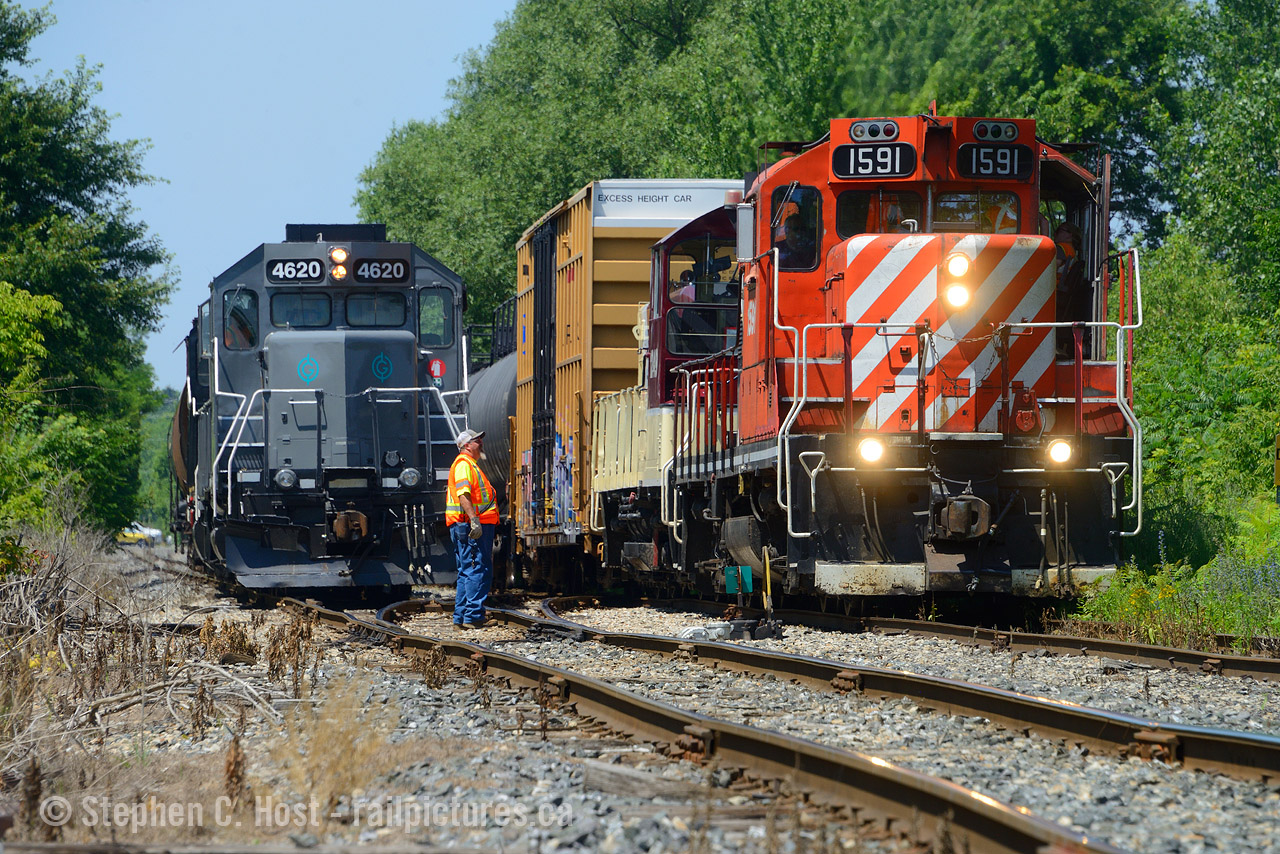 Two GP9's from different operators meet in St. Thomas Ontario as the St. Thomas turn's of both OSR and GIO help each other as they both try to leave town. Both trains would follow each other from St. Thomas yard, OSR would take the switch first and GIO would assist with throwing switches to help the OSR get out of town faster.