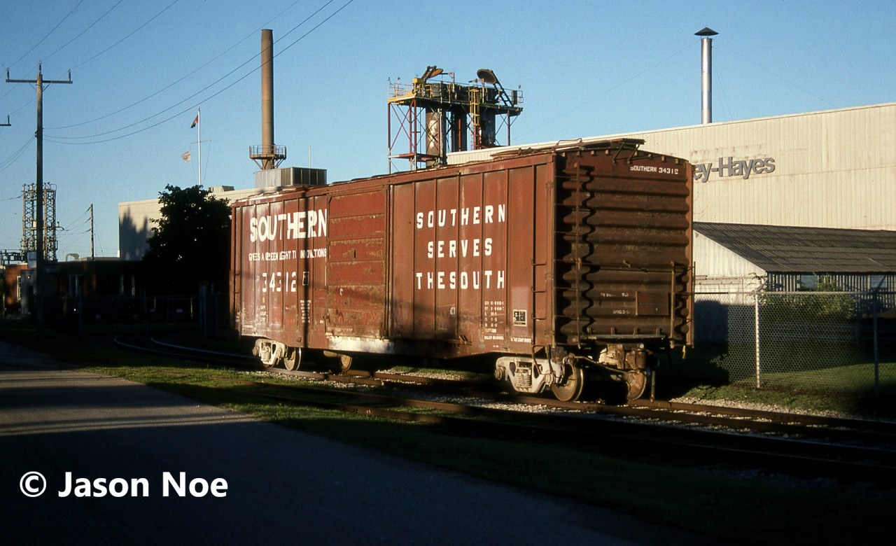 During an early summer morning, Southern Railroad boxcar 34312 basks in the sun as it sits outside the Kelsey-Hayes facility in Woodstock, Ontario. The industrial spur to this plant was located off the former CN Hickson Spur and the CP trackage to reach it was reconfigured, so it was accessed out of the Woodstock yard passing track near Oxford Street. The plant lasted a couple more decades before it was eventually shuttered and demolished.