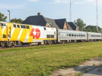 Still wearing the 40th Anniversary wrap, VIA 908 sits as train 78 makes its station stop. Always nice to see another railfan. Although, I'll miss seeing and hearing the sound of those stainless steel cars.
<br>
<br>
NOTE: off in the distance (to the right of the last car) was a classic CN boxcar. It sat on one of the many sidings, that were in place to serve many industries of 'yester-year'. CN had used it for storage, complete with a small deck with stairs. I had always planned to incorporate it into one of my photos, but sadly it was dismantled a few years ago. The area where all spare supplies (crossing lights, old gates etc.) was also fenced off then too.