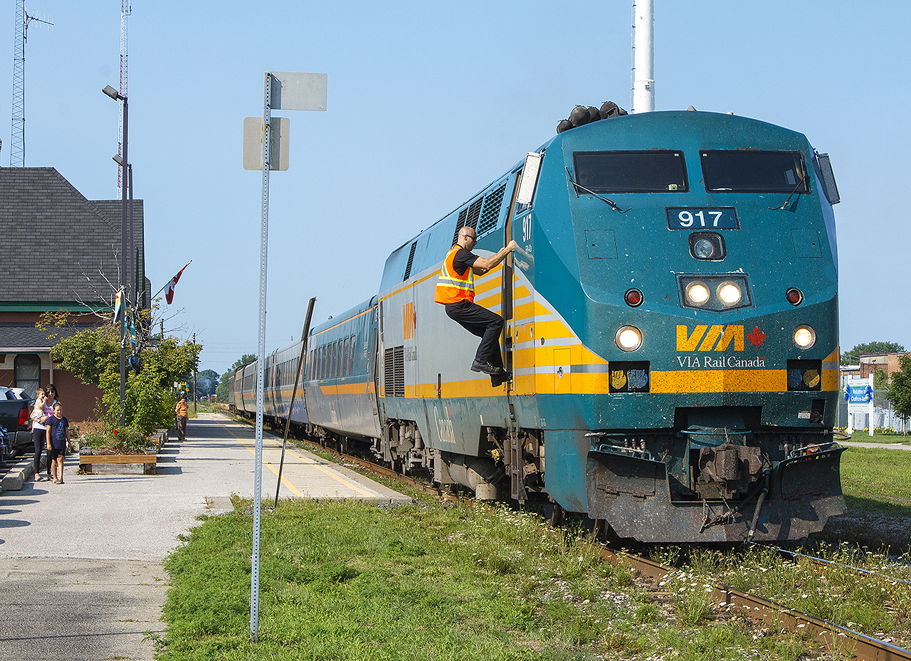 This is what its all about. 


Normally, I wouldn't post an everyday VIA train. Now looking back, the P42 'mud missiles' and F40s are slowly being replaced by the new Siemens sets on the Windsor to Quebec City corridor. BUT...this hot summer morning had lots of action as train 72 is about to depart, continuing east.


As the engineer slowly releases the brakes, the train is gaining speed as the conductor is entering through the cab door, after turning the key to instigate the protected Queen Steeet crossing. Before the conductor climbed back in, the trainee had already returned after learning the routine at what is normally a 10 minute station stop. To the right of the train's nose, is the 'Welcome to Chatham-Kent" sign for those who've never visited before (since removed). To the left, are what memories are made of...two youngsters excitedly watching the train, while having experienced the action of the trains station stop. 


And way down the line, in behind the scenes, is a plume of exhaust from the ageless CN GP9rm 7060, making a few last minute moves as it builds its train for the days run of the local L514, to Blenheim and Thamesville, returning later in the afternoon to Chatham.


Yup, this is what it's all about.