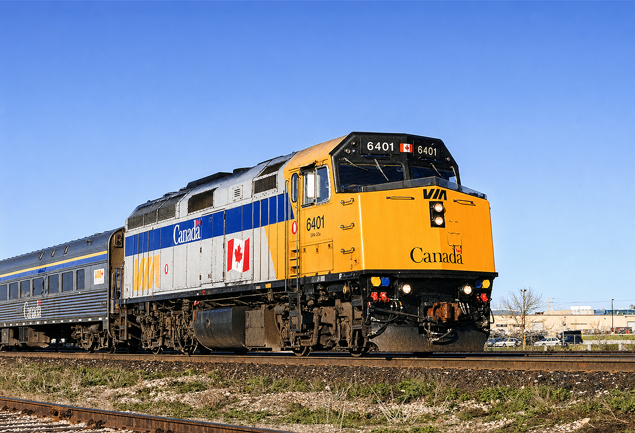 VIA F40PH-2 #6401 flies through Appleby GO station in Burlington, with the morning train from London to Toronto (I forget the train number). The widened blue stripe and added Canada heralds were still relatively new at the time. Also of note is the unique VIA Rail Canada logo on the car behind the locomotive- this style on a white background was only applied to HEP-2 car 4113.