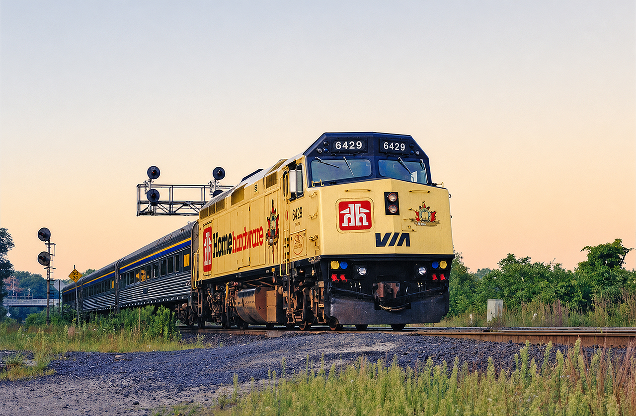 VIA F40PH 6429 in the Home Hardware scheme is seen passing through Bayview Junction on its way from Toronto Union Station to Niagara Falls. This evening train has long been cancelled and more or less been replaced by GO train service. When I took this photo in 1997 the HEP-2 cars were pretty much brand new (to VIA) and became regulars on this train at the time. The 6429 would go on to wear the slime green Telus advertisement before ultimately being rebuilt and repainted into standard Renaissance colors. While my original print came from the "August 1997" folder, I did not note the specific date of the photo, although I remember it being a muggy and warm evening.  I had just gotten my Nikon F50 as a gift and took as many pictures as my gas (and film/development/time) budget could afford.  Although most photos ended up not turning out (always the fun of shooting film!), I'm glad I did as the equipment that seemed boring and mundane then is now mostly lost to history.
